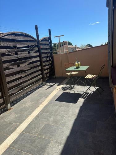 un patio avec une table et des chaises sur un balcon dans l'établissement Apparemment Vias plage-village, à Vias