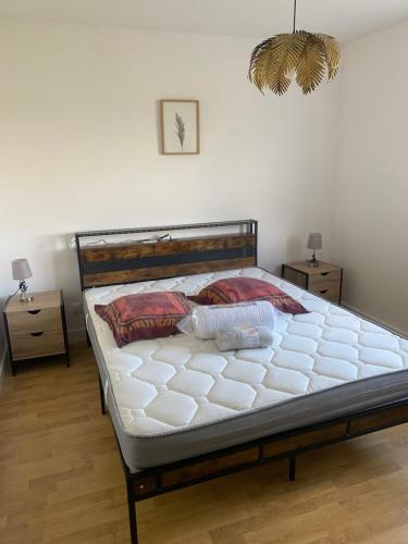 a bed in a bedroom with two night stands and two tables at Maison de la tranquillité 12 personnes maxi avec Spa in Doncières