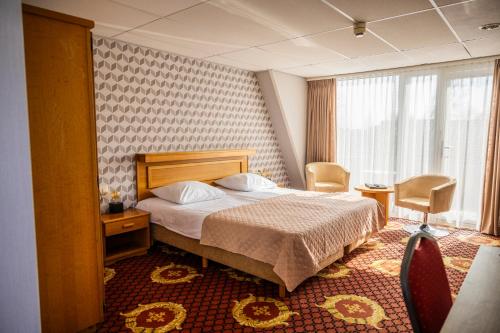 Postel nebo postele na pokoji v ubytování Hotel Restaurant Boschlust
