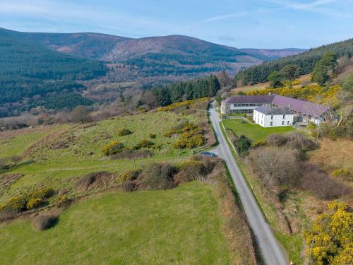an aerial view of a house on a hill with a road at Knockree Hostel in Enniskerry