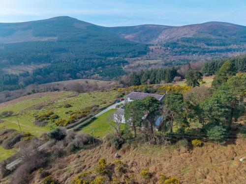 an aerial view of a house on a hill with a road at Knockree Hostel in Enniskerry