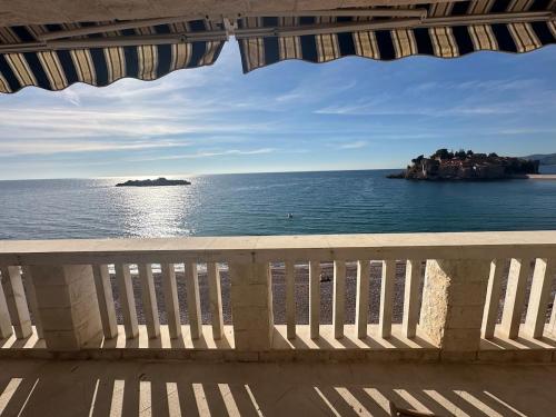 a view of the ocean from a balcony at Beachfront Four Bedroom Apartment in Sveti Stefan