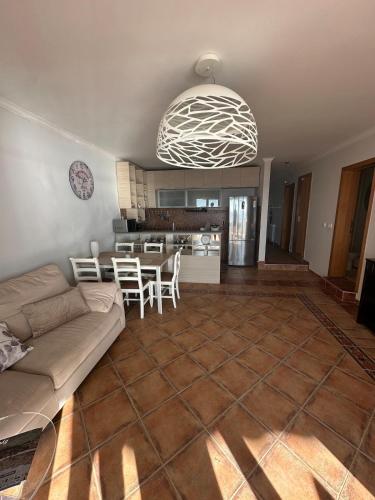 a living room with a couch and a table at Beachfront Four Bedroom Apartment in Sveti Stefan
