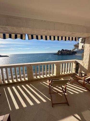 a view of the ocean from a balcony at Beachfront Four Bedroom Apartment in Sveti Stefan