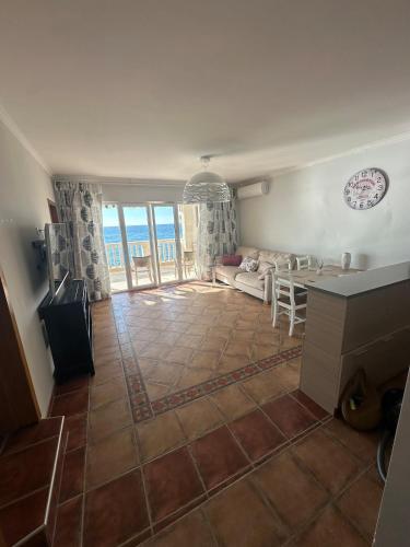 a living room with a couch and a table at Beachfront Four Bedroom Apartment in Sveti Stefan