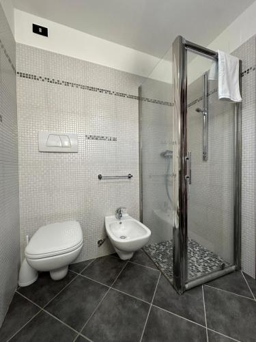 a bathroom with a shower and a toilet and a sink at 5 stelle Dimora storica in Valle D'Itria con WIFI in Turi