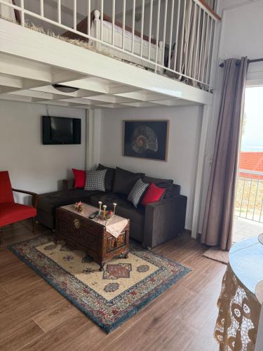 a living room with a couch and a loft at Nature Paradise Apartment in Kardítsa