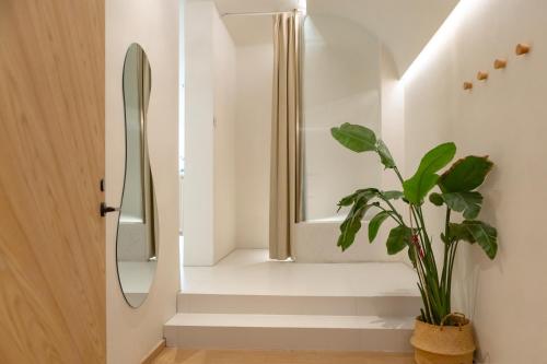 a bathroom with a mirror and a potted plant at EUPHORIA丨Quiet Garden Quiet Designer Garden Hotel丨Datang Never Sleeps City Big Wild Goose Pagoda Subway Station Branch丨Near the scenic area in Xi'an