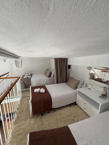 a hotel room with two beds and a staircase at Nature Paradise Apartment in Kardítsa