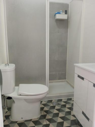 a white bathroom with a toilet and a shower at Lisbon Guesthouse in Lisbon
