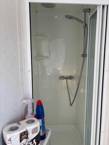 a bathroom with a shower with a glass door at 148 Port Haverigg in Millom