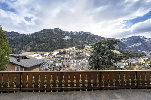 a balcony with a view of a town and mountains at Panorama Apartments Walter in Ortisei
