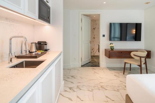 a kitchen with a sink and a counter top at Cheval Maison - Expo City Dubai in Dubai