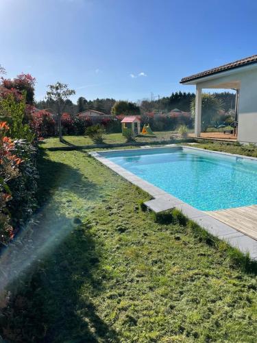 une piscine dans une cour à côté d'une maison dans l'établissement Maison de vacances avec piscine idéalement située, à Carcans