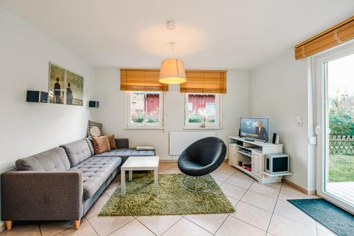 a living room with a couch and a tv at FH Seidenstücker in Breege