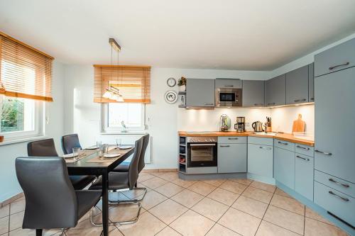 a kitchen with a table and a dining room at FH Seidenstücker in Breege