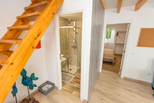 a staircase in a room with a shower and a bathroom at O Quintal Guesthouse in Carvoeiro