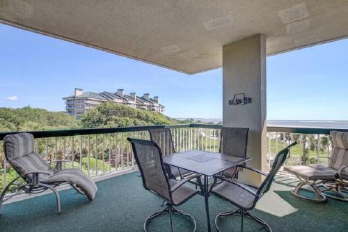 a balcony with a table and chairs on a balcony at Ocean Club 1208 by Wild Dunes, Oceanfront in Isle of Palms