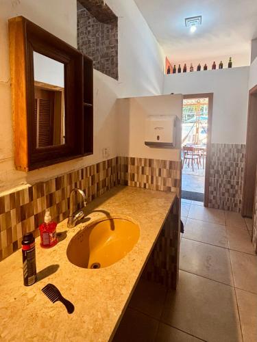a kitchen with a sink and a counter top at Hostel São Lourenço in Bertioga