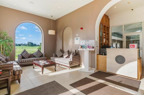 a living room with a couch and a table at Best Western Lamphey Court Hotel and Spa in Lamphey