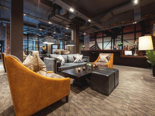 a living room with couches and a coffee table at Dakota Edinburgh in Queensferry