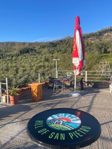a sign for a bar with an umbrella and a table at HILL Of SAN PIETRO in Durrës