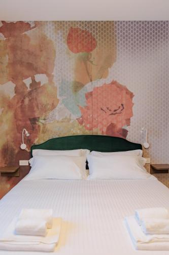 a bed with two white pillows in a bedroom at OPHELIA Hotel in Cazzago San Martino