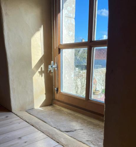 an open door to a window in a room at Le Fournil de Sainte Mère Eglise in Sainte-Mère-Église