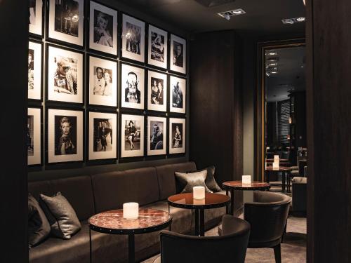 a restaurant with two tables and chairs and pictures on the wall at Dakota Leeds in Leeds