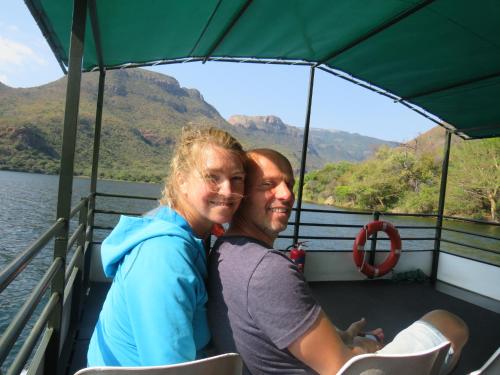 a man and woman on a boat on the water at The Baobab Bush Lodge and Villa in Hoedspruit