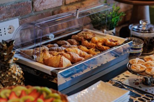 a bunch of different types of bread and pastries at OPHELIA Hotel in Cazzago San Martino