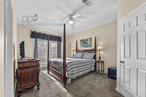 a bedroom with a bed and a ceiling fan at Legacy Villa 504 in Gulfport