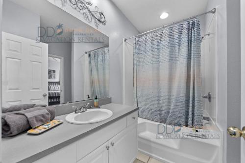 a white bathroom with a sink and a shower at Legacy Villa 504 in Gulfport