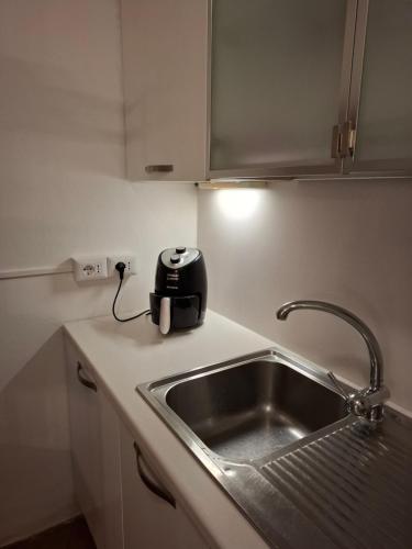 a kitchen with a sink and a toaster on a counter at Suite "La Finestra su Alghero" in Alghero