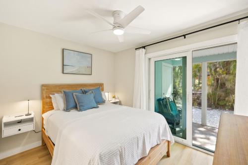 a bedroom with a bed and a sliding glass door at The Driftwood Inn in Sanibel