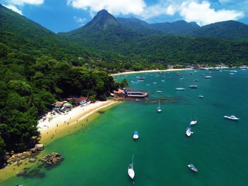 an aerial view of a beach with boats in the water at Casa da Ilha & SPA in Abraão
