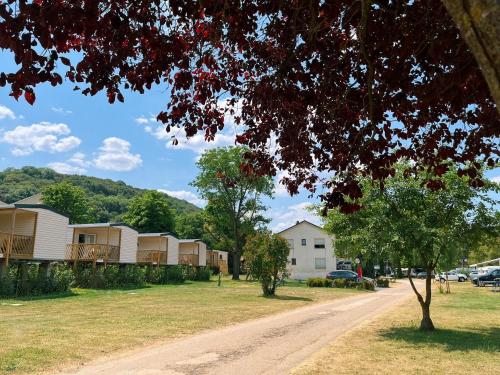 a dirt road leading to a row of mobile homes at Chalet Hohllay in Reisdorf