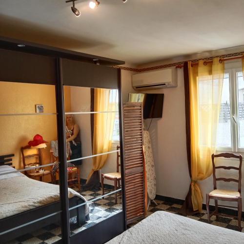 - une personne dans une chambre avec un lit et un miroir dans l'établissement Grand Appartement T2 avec parking et clim à 50m de la Plage centrale !, à Canet