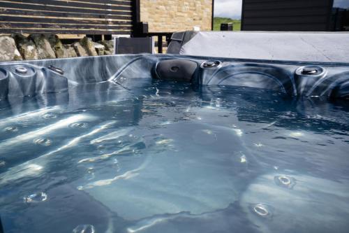 a large pool of water in a metal tub at Hayloft Cottage - North East Escapes in Bamburgh