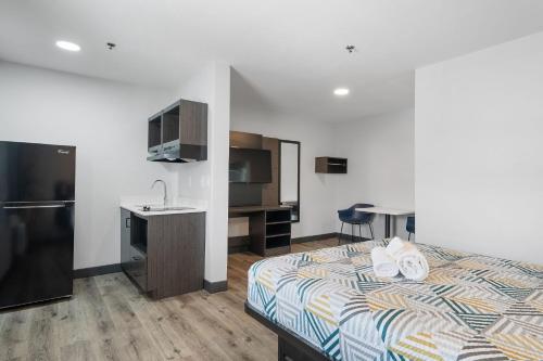 a hotel room with a bed and a sink at Southern Suites Pensacola Mobile Hwy in Pensacola