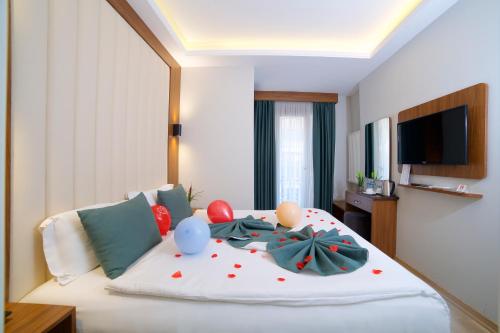 a bedroom with a bed with balloons on it at Hotel Black Tulip in Istanbul