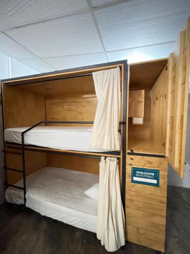 a bunk bed in a room with a sign on it at The Boat House Cancun in Cancún