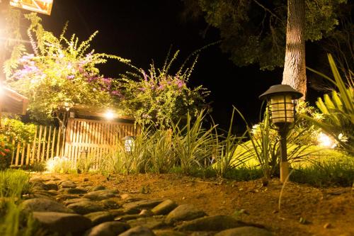 a street light in a garden at night at Pousada da Mata in Iriri