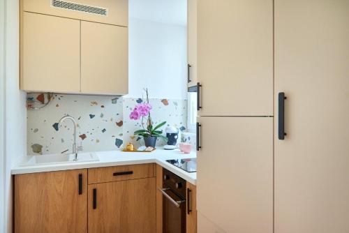 a kitchen with a refrigerator and a sink at Apartament Mono Lux in Zamość