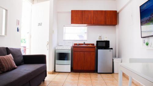 a living room with a couch and a kitchen at Boulevard Park IV 202 in Mayaguez