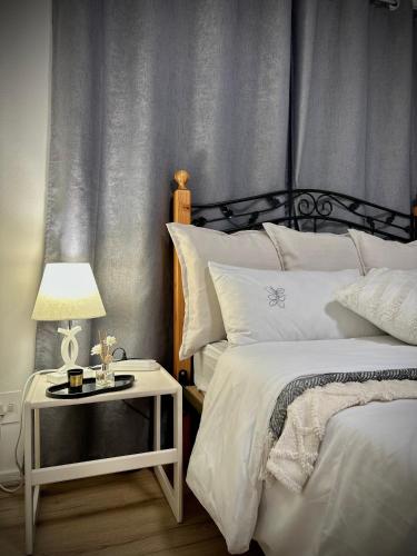 a bedroom with two beds and a table with a lamp at Mario & Luiza's Place - Cozy Stay with Pool & Braai in Worcester