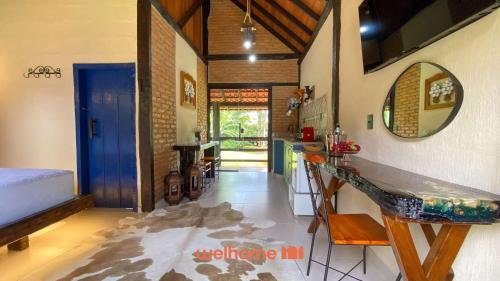 a living room with a counter and a mirror at Chalé em Venda Nova com vista para a montanha in Venda Nova do Imigrante