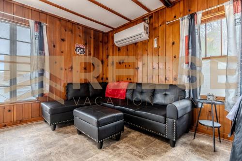 a living room with leather furniture and a couch at Beach Cabin #5 in Lake Ozark