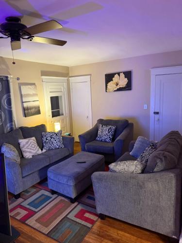 a living room with two couches and two chairs at Gorgeous 3 BR Upper Unit Home in Buffalo