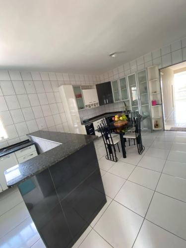 a kitchen with a table and some chairs in it at Casa privada 3 quartos ótima localização in Piranhas